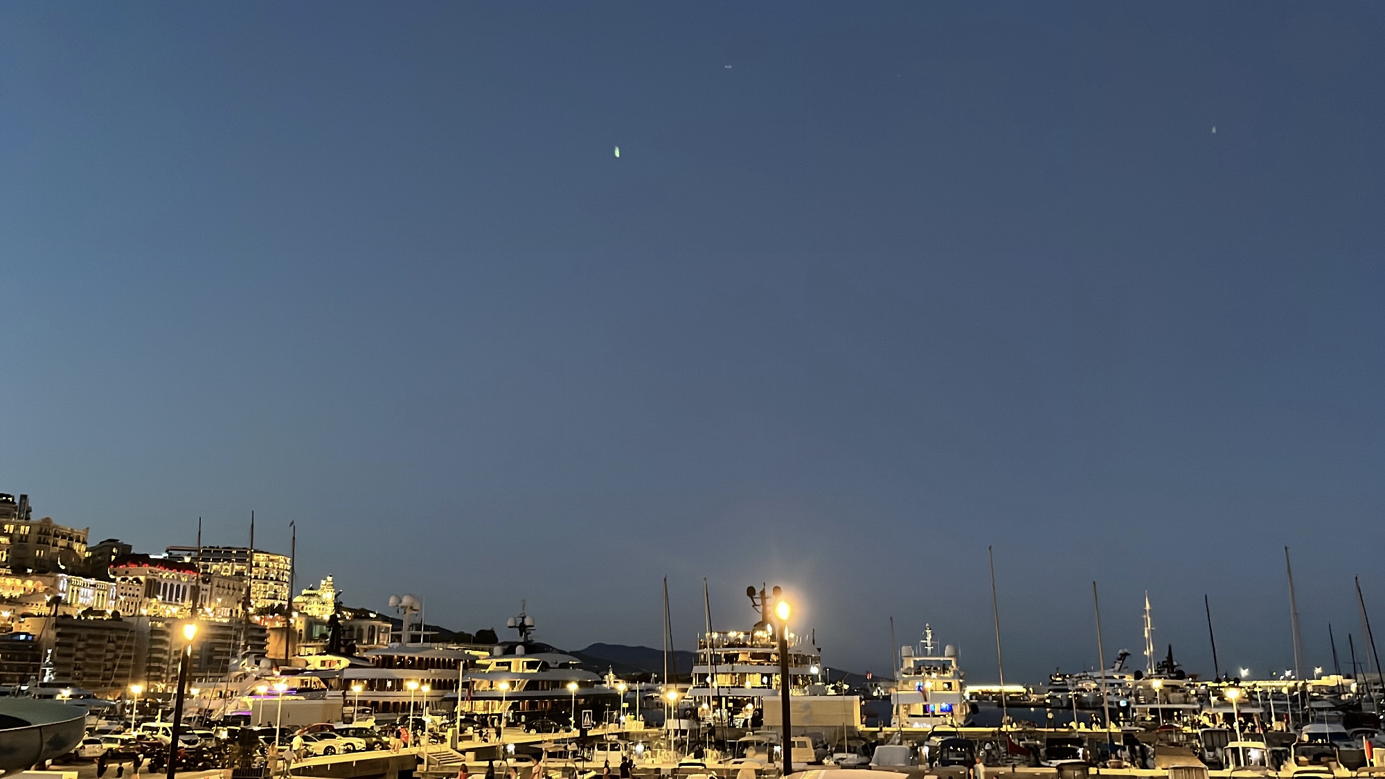 Din Tanovic — Port Hercule at dusk before Monaco Art en Ciel, superyachts and quiet blue sky