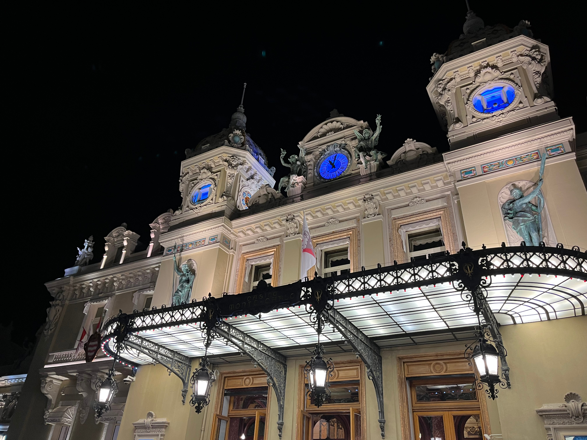 Din Tanovic — façade of Casino de Monte-Carlo at night, blue clock glowing