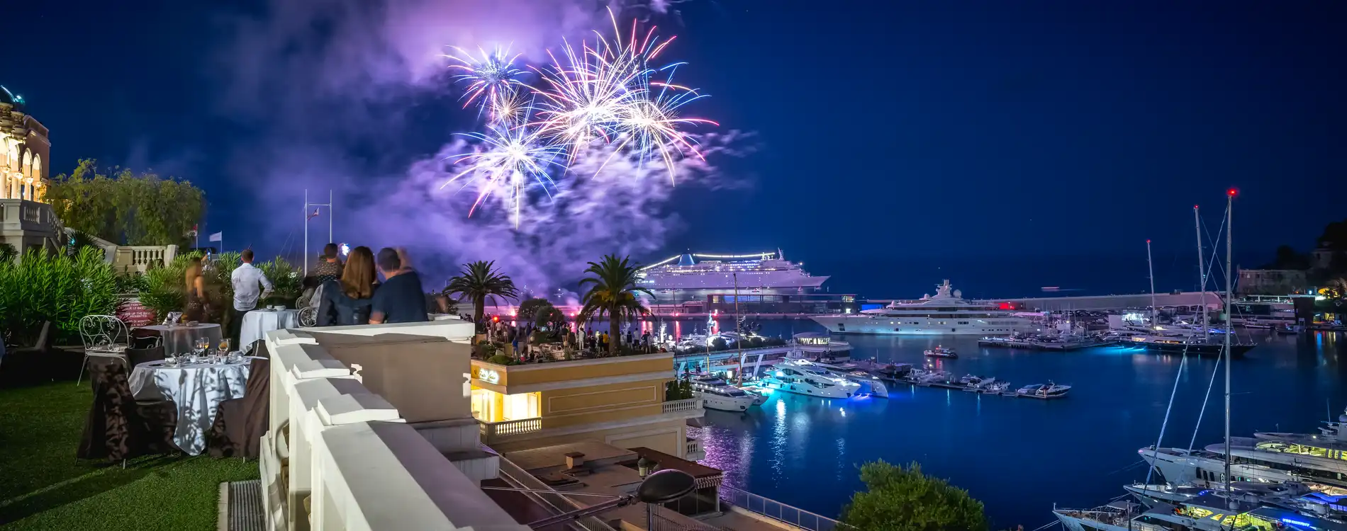 Din Tanovic — fireworks over Port Hercule from a terrace in Monaco, superyachts glowing below