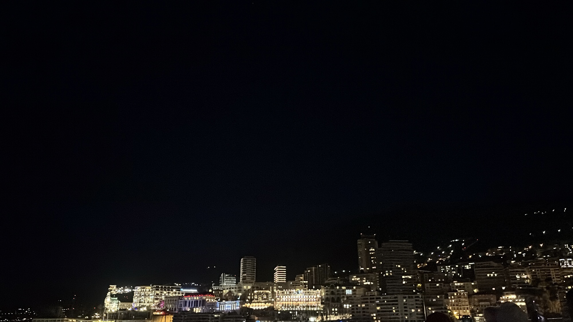 Din Tanovic — Monte Carlo cityscape at full night, warm lights climbing the hills